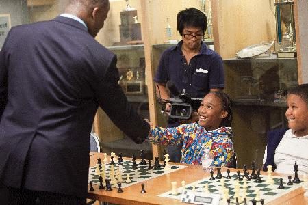 GM Maurice Ashley greets a student before a simultaneous exhibition at the U.S. Chess Center