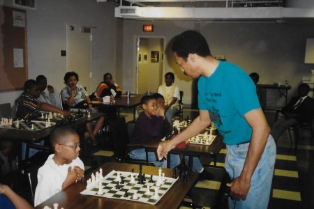 Greg Acholonu plays a simultaneous exhibition against U.S. Chess Center students